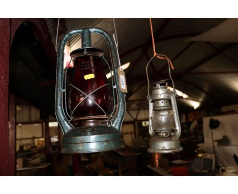 A Monarch of New York red glass hurricane lamp and another lamp