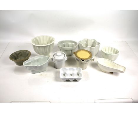 A collection of white glazed china jelly moulds and a Clarke's patent pyramid night light etc.