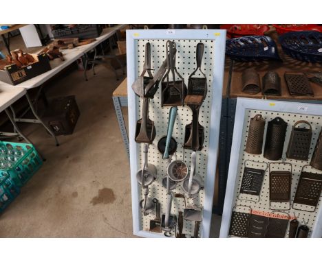 A display board of vintage food crushers and graters 