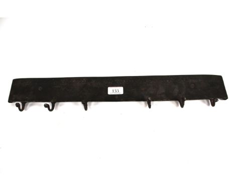 A 19th Century wrought iron utensil rack with incised decoration, approx. 22&frac12;" long