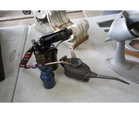 A vintage blow lamp and two oil cans