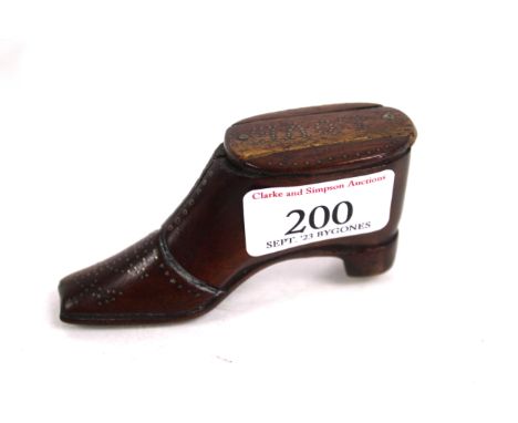 A 19th Century treen snuff box in the form of a shoe with brass pin work decoration, including the word "Love inscribed onto 