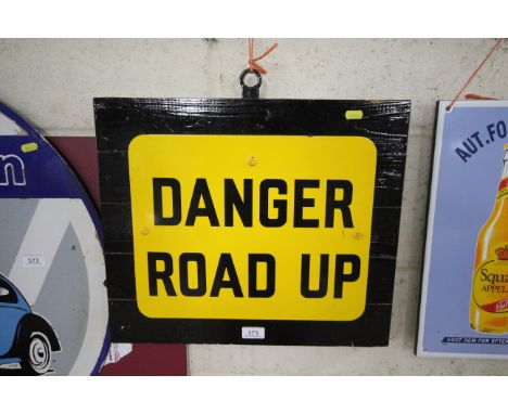 A Enamel Danger, "Road Up" sign set to a wooden plinth