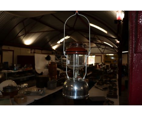 A Tilley storm lamp with chrome font