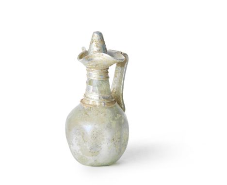  A Roman colourless glass jug with biconical stopper Circa 3rd-4th Century A.D.The globular body with concave base and dimple