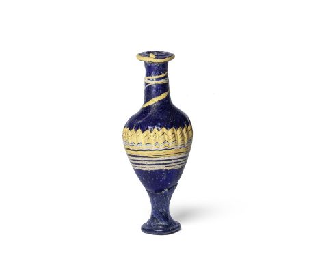 A Greek core-formed glass unguentarium Circa 3rd Century B.C.Of cobalt-blue glass, with opaque yellow edged rim, continuing 