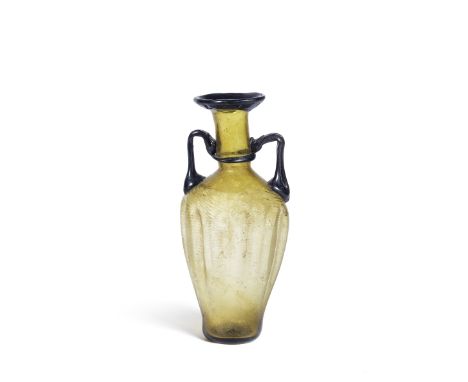  A Roman amber glass amphora Circa 3rd-4th Century A.D.The body with wrythen moulded spiral ribbiing and eleven uneven dimple