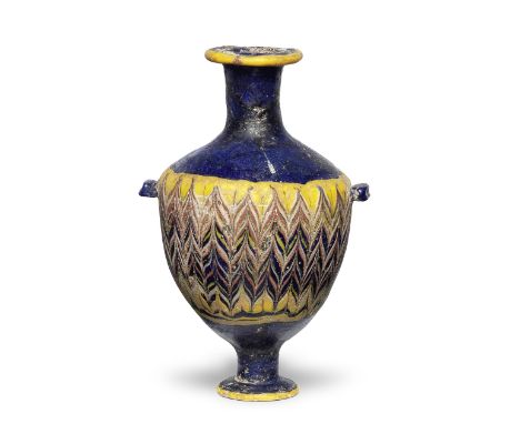  A Greek core-formed glass unguentarium Circa 3rd Century B.C.Of cobalt-blue glass, the ovoid body with opaque yellow, red, w