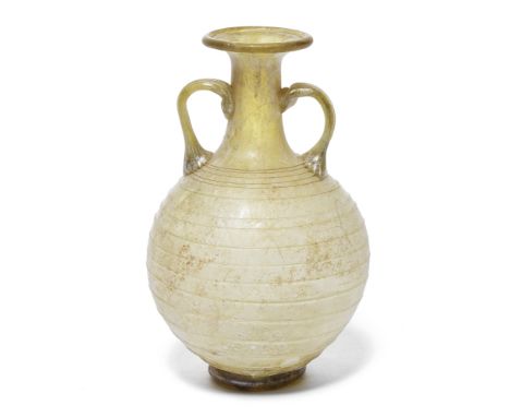  A Roman yellow-green glass amphoriskos  Circa 1st Century A.D.The globular body decorated with a continuous line of fine spi