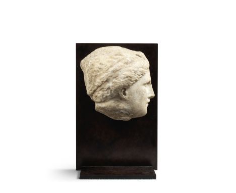  A sizeable Greek marble head of a goddess Circa 4th-3rd Century B.C.The profile head carved in high relief, portrayed with t