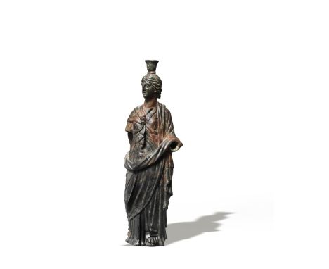  A Roman bronze figure of Isis-Fortuna Circa 1st Century A.D.Wearing a diadem in her wavy hair, surmounted by a modius,  gazi