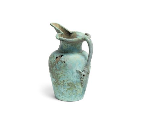  An Etruscan bronze oinochoe Circa 5th Century B.C. The ovoid tapering body with a short cylindrical neck, the trefoil mouth 