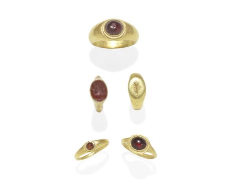  Four small Roman gold children's rings Circa 1st Century B.C. - 3rd Century A.D.Comprising a garnet cabochon ring; a carneli