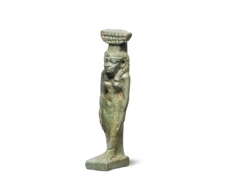  An Egyptian green glazed faience amulet of Nephthys Late Period, circa 664-332 B.C.Wearing the hieroglyph of her name on her