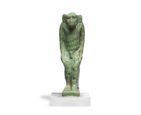  An Egyptian green glazed faience amulet of a vervet monkey Third Intermediate Period, circa 1069-735 B.C.Depicted standing s