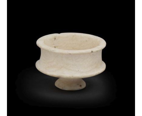 A small Egyptian travertine footed cup 'tazza'  New Kingdom, circa 1550-1069 B.C.Carved from one piece, set on a flared foot