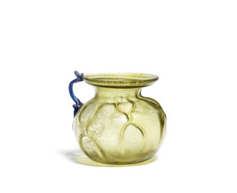  A Roman moss-green glass handled cup Circa 4th Century A.D.The spherical body with six groups of pincered ribs forming a net