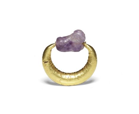  An Egyptian amethyst amuletic recumbent sphinx   Middle Kingdom, circa 2025-1700 B.C.Mounted on a Roman gold navicella-shape