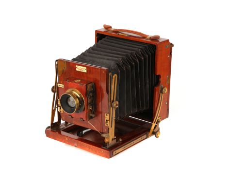 A Sanderson Junior Half Plate Mahogany Field Camera, 1900, with Busch's Wideangle Aplanat No.3 f/16 brass lens, in roller bli