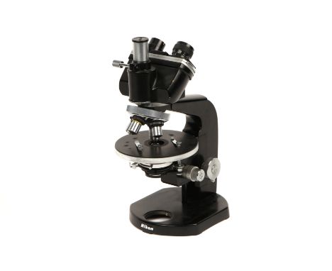 A Nikon Trinocular Microscope, serial no.75922, finished in black, four objective turret with four objectives including,  Nik