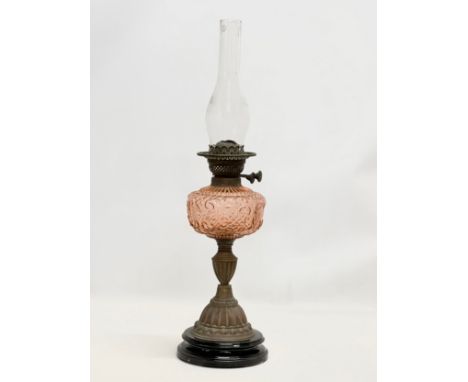 A large 19th Century Victorian double burner oil lamp. With cranberry glass bowl and brass column. 65cm 