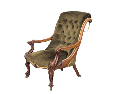 A Victorian mahogany framed open armchair with deep button back upholstery. 