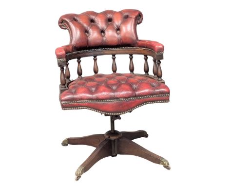 A Victorian style deep button ox-blood leather swivel desk chair. 3 