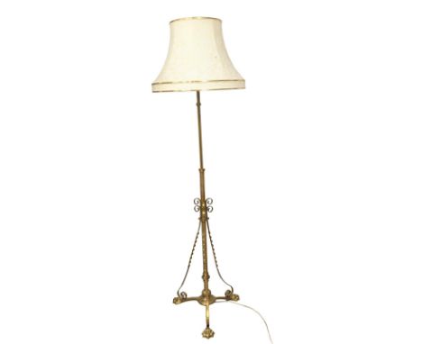 A large Early 20th Century brass telescopic standard lamp on lion paw feet. 194cm(9) 