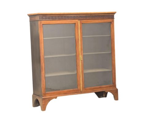 An Edwardian inlaid mahogany 2 door bookcase on bracket feet. Circa 1900-1910. 111x33x117cm.(9) 