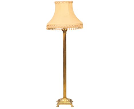A vintage brass standard lamp with Corinthian style column on lion paw feet. 168cm. 1 