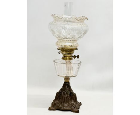 A Late 19th Century Victorian double burner oil lamp, with slice cut glass bowl and cast iron base. Later shade. 59cm 