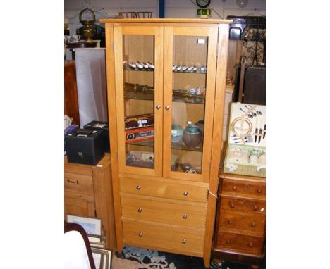A modern light oak display bookcase - width 82cms