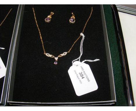 A 9ct gold purple stone pendant on chain, together with the matching earrings 