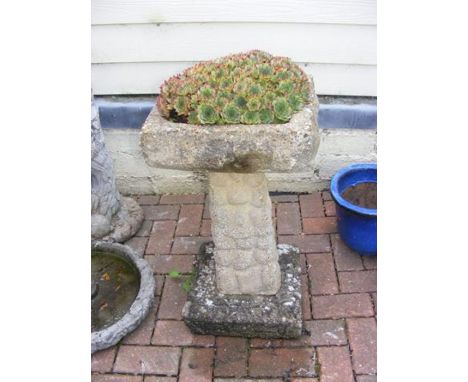 A concrete birdbath/planter
