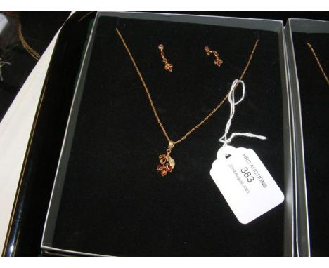 A 9ct gold 'flower' pendant on chain, together with the matching earrings 
