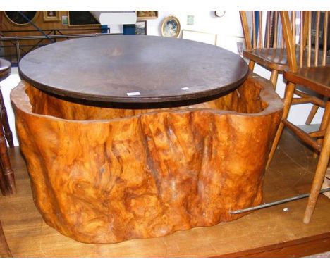 A tree trunk coffee table with replacement top 