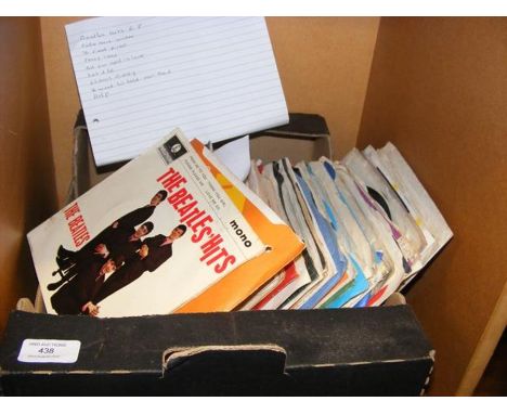 A selection of vintage 45rpm records including Beatles Hits