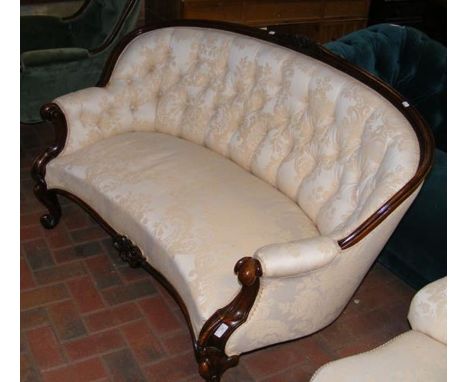 A Victorian curved back settee upholstered in light cream floral material 
