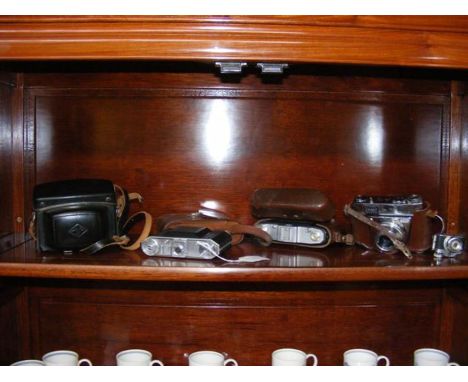 A number of vintage cameras, including Kodak 