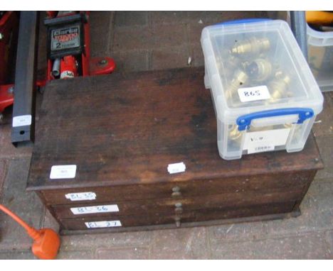 A wooden cabinet with tools and a box of light fittings