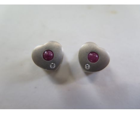 A pair of 18ct white gold heart shaped earrings set with a small diamond, 10mm wide, approx 4 grams 