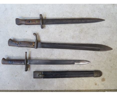 A Waffenfabrik Mauser bayonet - 59cm long, a bayonet and scabbard number VW9943 and a Wilkinson bayonet - 42cm long, please s