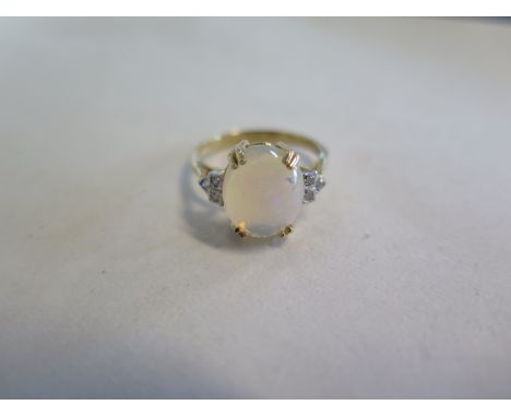 A 9ct opal and diamond ring, size P, approx 3 grams, opal approx 11mm x 10cmm - good overall condition 