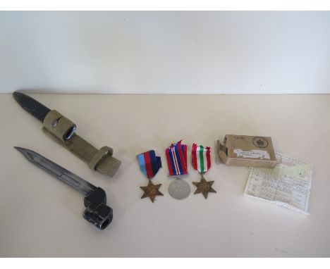 Three WWII unnamed medals with box and a bayonet and scabbard 