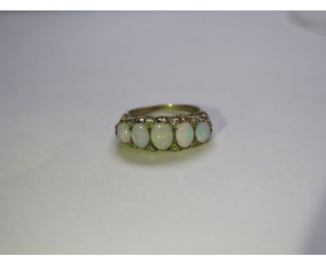 A five stone opal and diamond ring, largest opal approx 6mm oval, 9ct gold band, ring size N, approx 5.3 grams, gold rubbed, 