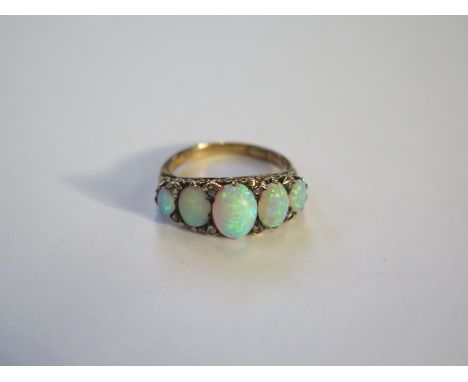 An 18ct gold five stone opal ring, size L, approximately 4.3g, condition consistent with regular use 