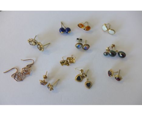 Eleven pairs of 9ct earrings set with various stones including opal, amber, pearl and diamond, some missing backs, see images