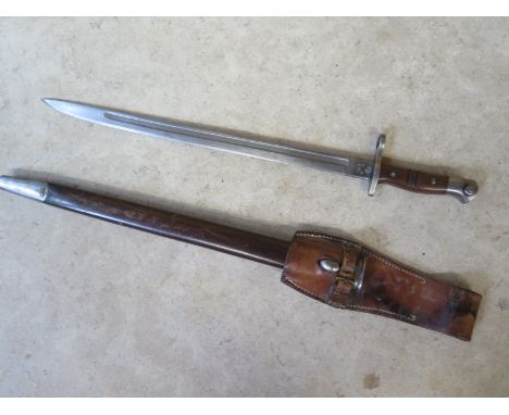 A 1913 pattern Remington sword bayonet, with scabbard, in overall good condition, some wear to leather 