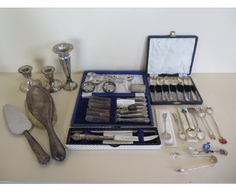 An assortment of silver flatware, inc a cased set of six silver teaspoons also a silver vesta case, a silver spill vase, and 