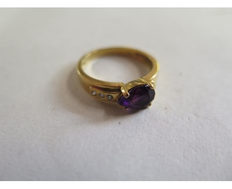 An 18ct yellow gold amethyst and diamond ring, size M, approx 3.5 grams - good condition 